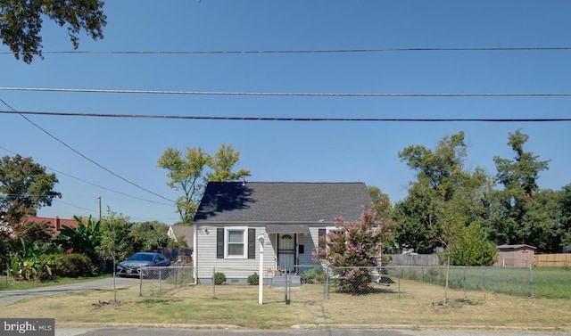 bungalow-style house featuring a front lawn