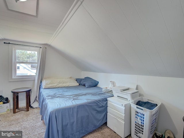 bedroom with light colored carpet and vaulted ceiling