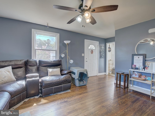 living room featuring ceiling fan and dark hardwood / wood-style flooring