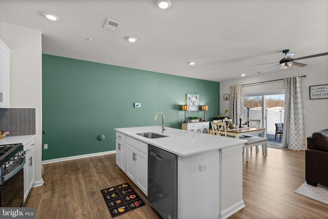 kitchen with a center island with sink, white cabinets, sink, ceiling fan, and stainless steel appliances