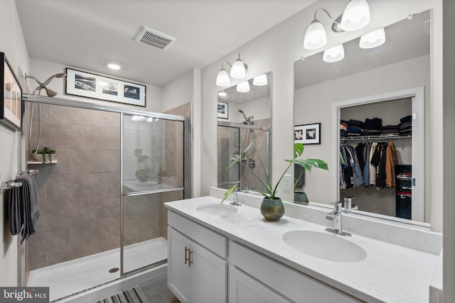 bathroom with vanity and a shower with door