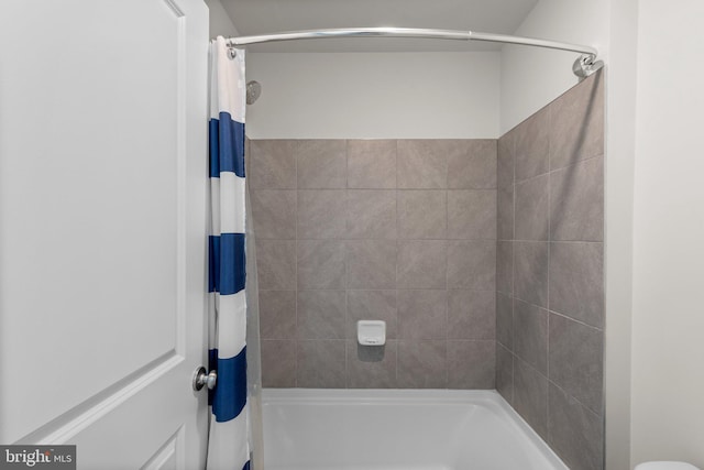 bathroom featuring shower / bathtub combination with curtain