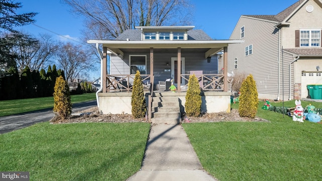 bungalow-style house with covered porch and a front lawn