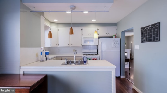 kitchen featuring kitchen peninsula, white cabinetry, white appliances, and sink