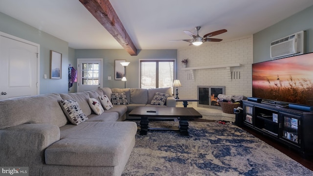 living room with ceiling fan, beam ceiling, a fireplace, and a wall unit AC