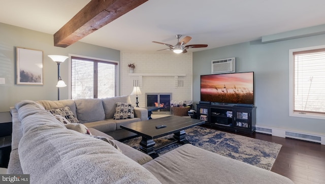 living room with ceiling fan, a brick fireplace, beamed ceiling, dark hardwood / wood-style floors, and an AC wall unit