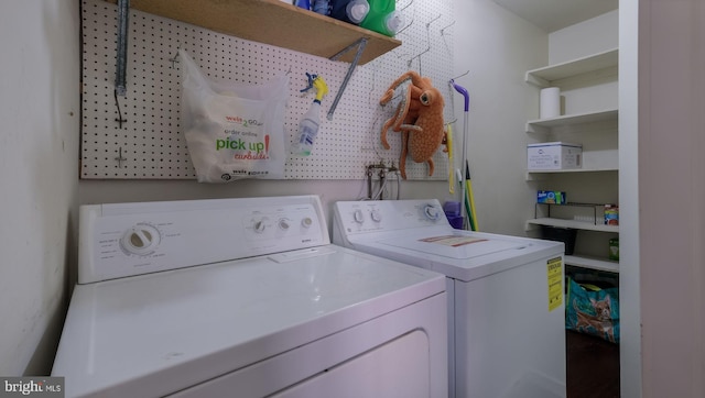 washroom featuring washer and clothes dryer