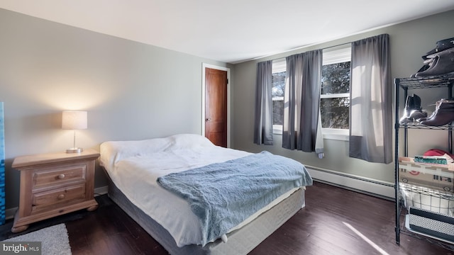 bedroom featuring dark hardwood / wood-style floors and baseboard heating