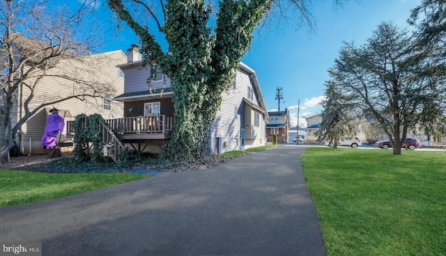 view of side of home featuring a lawn