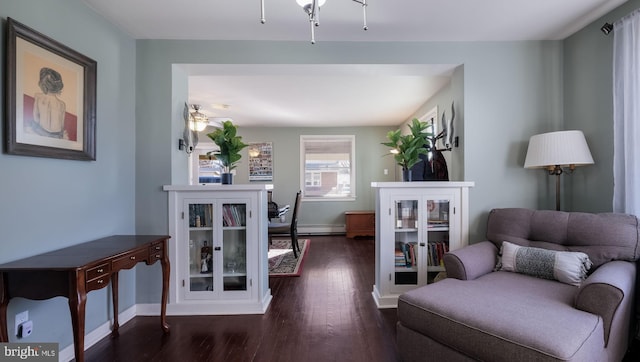 sitting room featuring ceiling fan and dark wood-type flooring