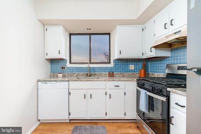 kitchen featuring stainless steel gas stove, dishwasher, sink, light hardwood / wood-style flooring, and white cabinets