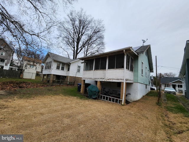 back of property with a sunroom