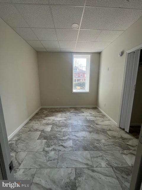 unfurnished room featuring a paneled ceiling