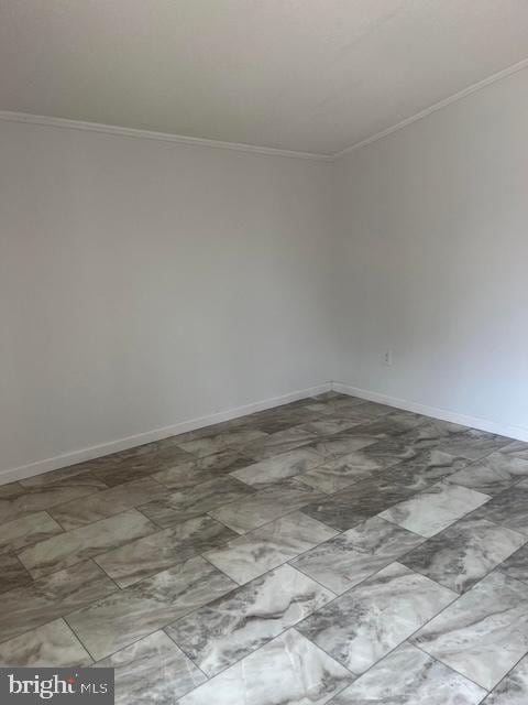 unfurnished room with crown molding