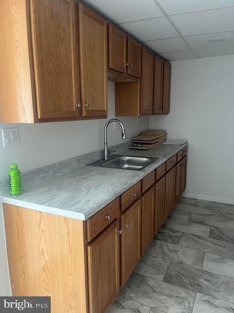 kitchen with sink and a paneled ceiling