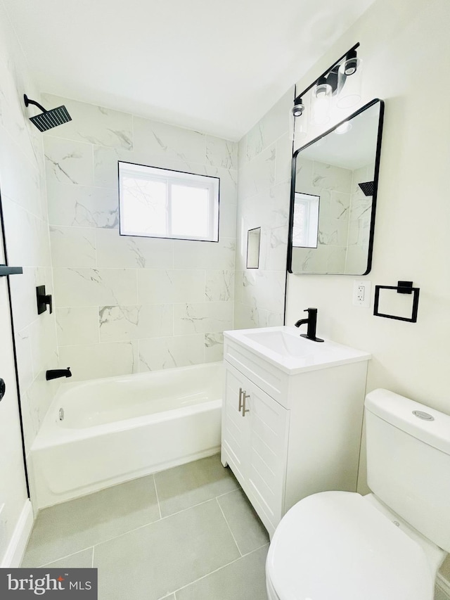 full bathroom with tile patterned floors, vanity, toilet, and tiled shower / bath