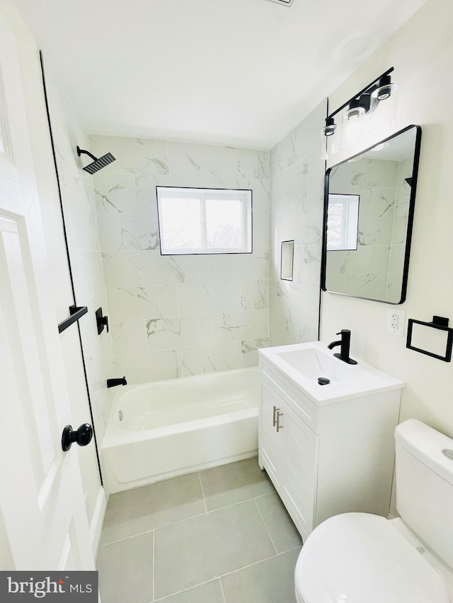 full bathroom featuring tile patterned flooring, vanity, toilet, and tiled shower / bath