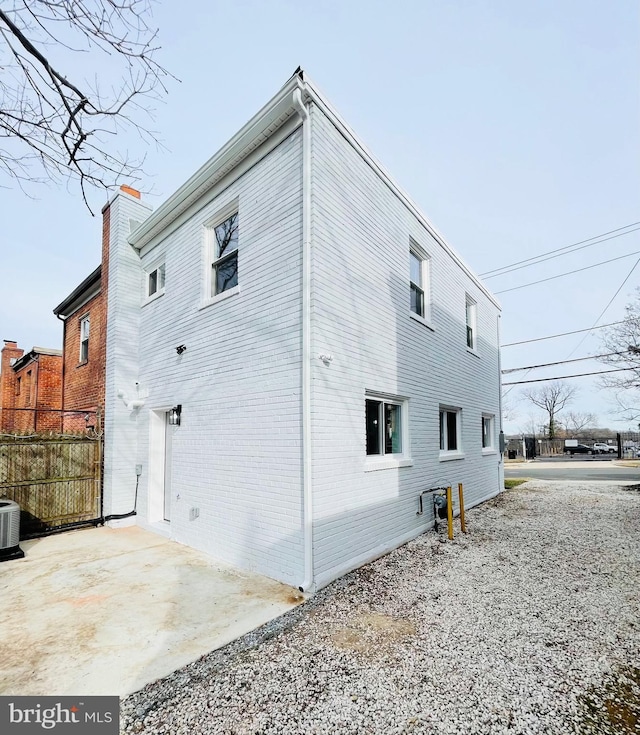 back of property featuring central AC unit