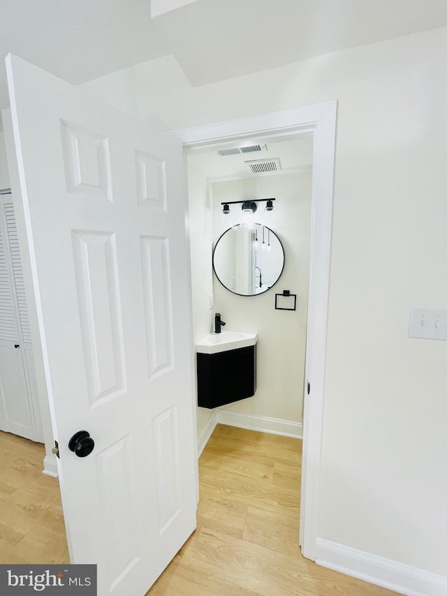 bathroom with hardwood / wood-style floors and vanity