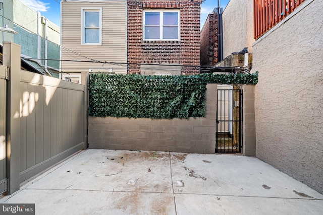 view of gate with a patio