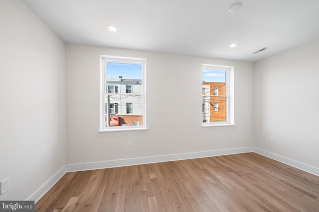 empty room with light hardwood / wood-style flooring