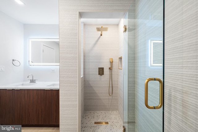 bathroom featuring vanity, walk in shower, and tile patterned flooring