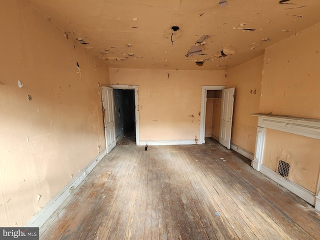 unfurnished living room with hardwood / wood-style floors