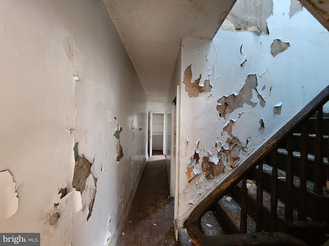 hall with a textured ceiling