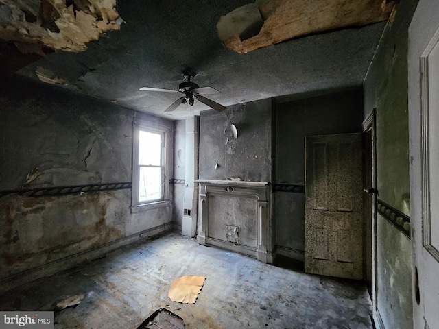 interior space with ceiling fan