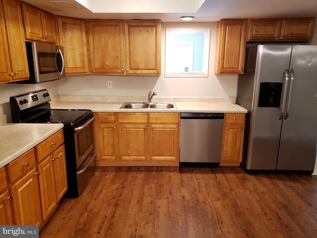 kitchen featuring hardwood / wood-style floors, sink, and stainless steel appliances