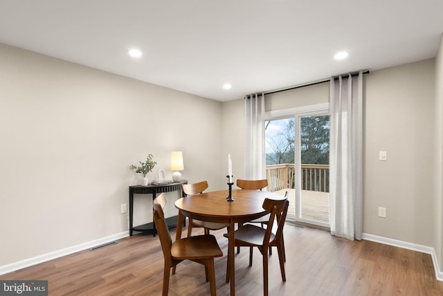 dining area featuring recessed lighting, wood finished floors, visible vents, and baseboards