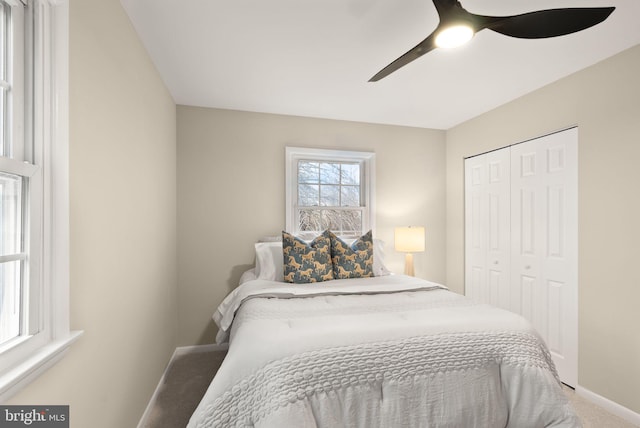 bedroom with carpet, a closet, ceiling fan, and baseboards