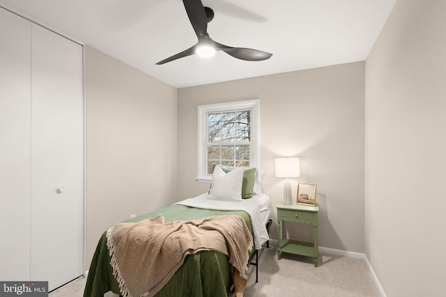 bedroom with baseboards, a ceiling fan, and light colored carpet