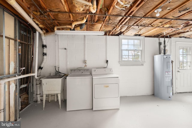 laundry area featuring laundry area, a wealth of natural light, washing machine and clothes dryer, and electric water heater