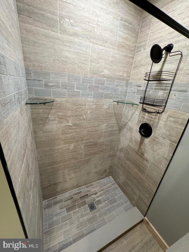 bathroom with tiled shower