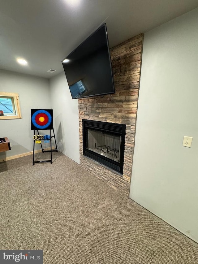 unfurnished living room featuring a fireplace and carpet