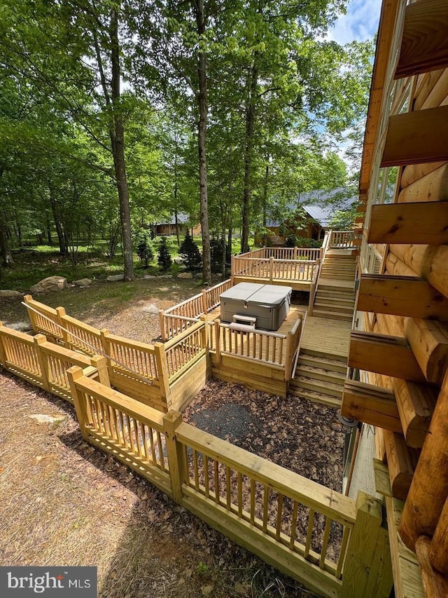 wooden deck featuring a hot tub