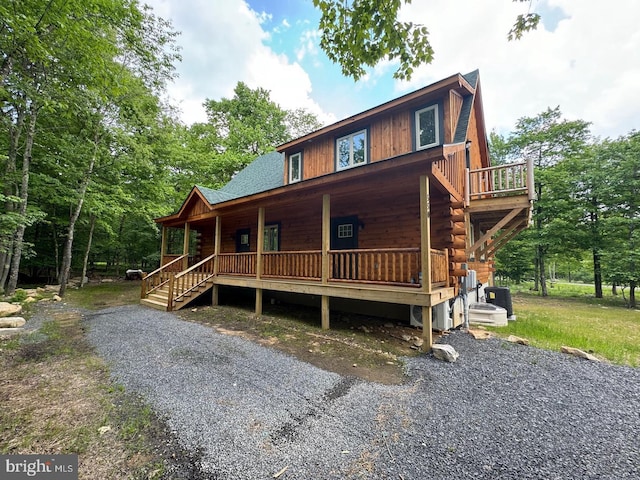 cabin featuring a porch and cooling unit