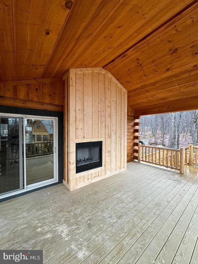 wooden deck with exterior fireplace