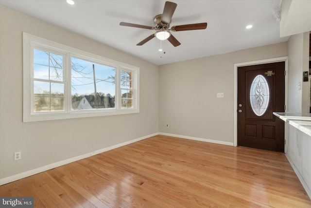 entrance foyer with ceiling fan and light wood-type flooring