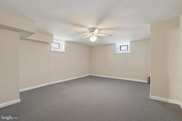 basement with dark colored carpet and a wealth of natural light