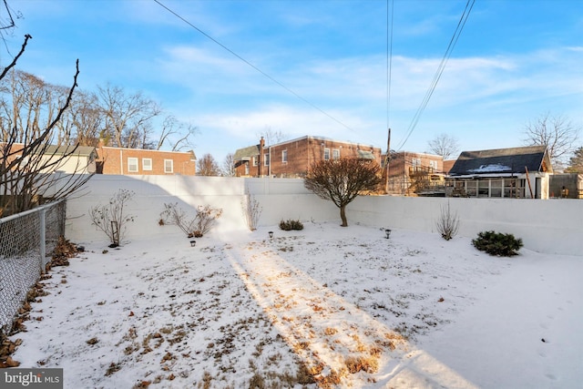 view of yard layered in snow