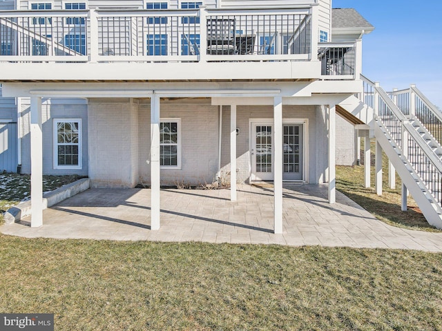 rear view of property featuring a yard and a patio area