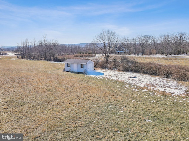 exterior space featuring an outdoor structure and a rural view