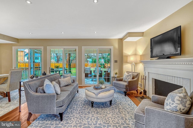 living room with hardwood / wood-style floors, a fireplace, and french doors