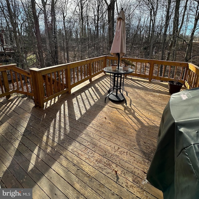 wooden deck with a grill