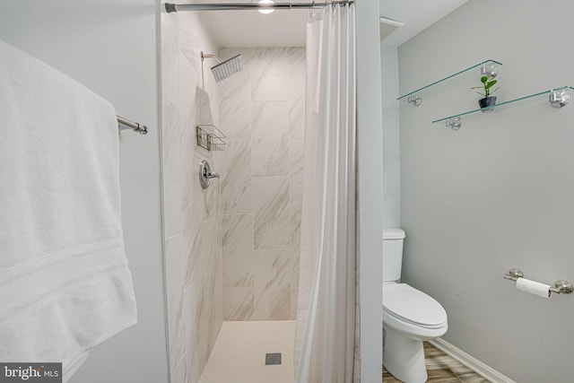 bathroom with toilet and walk in shower