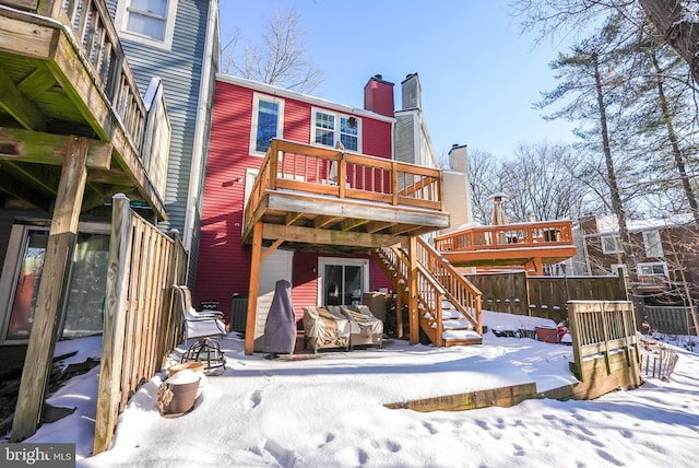 snow covered property featuring a balcony