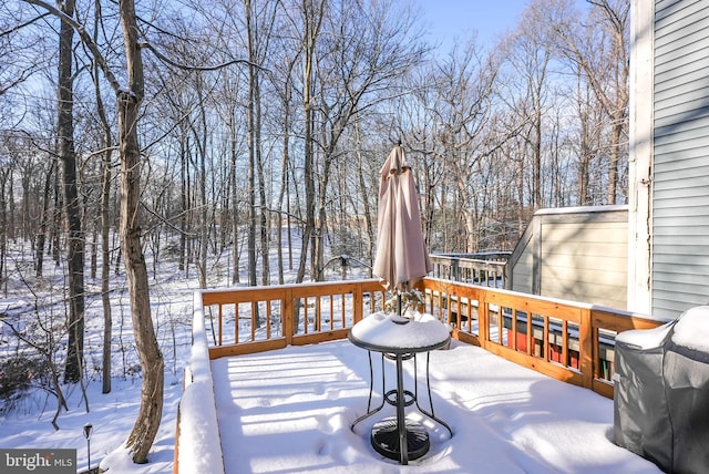 snow covered deck featuring a grill