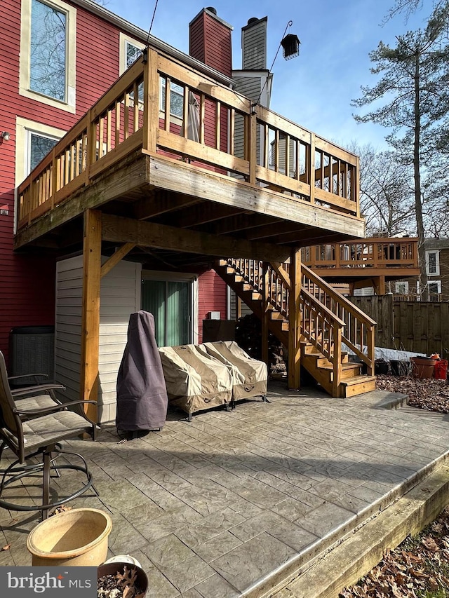 rear view of property with a wooden deck